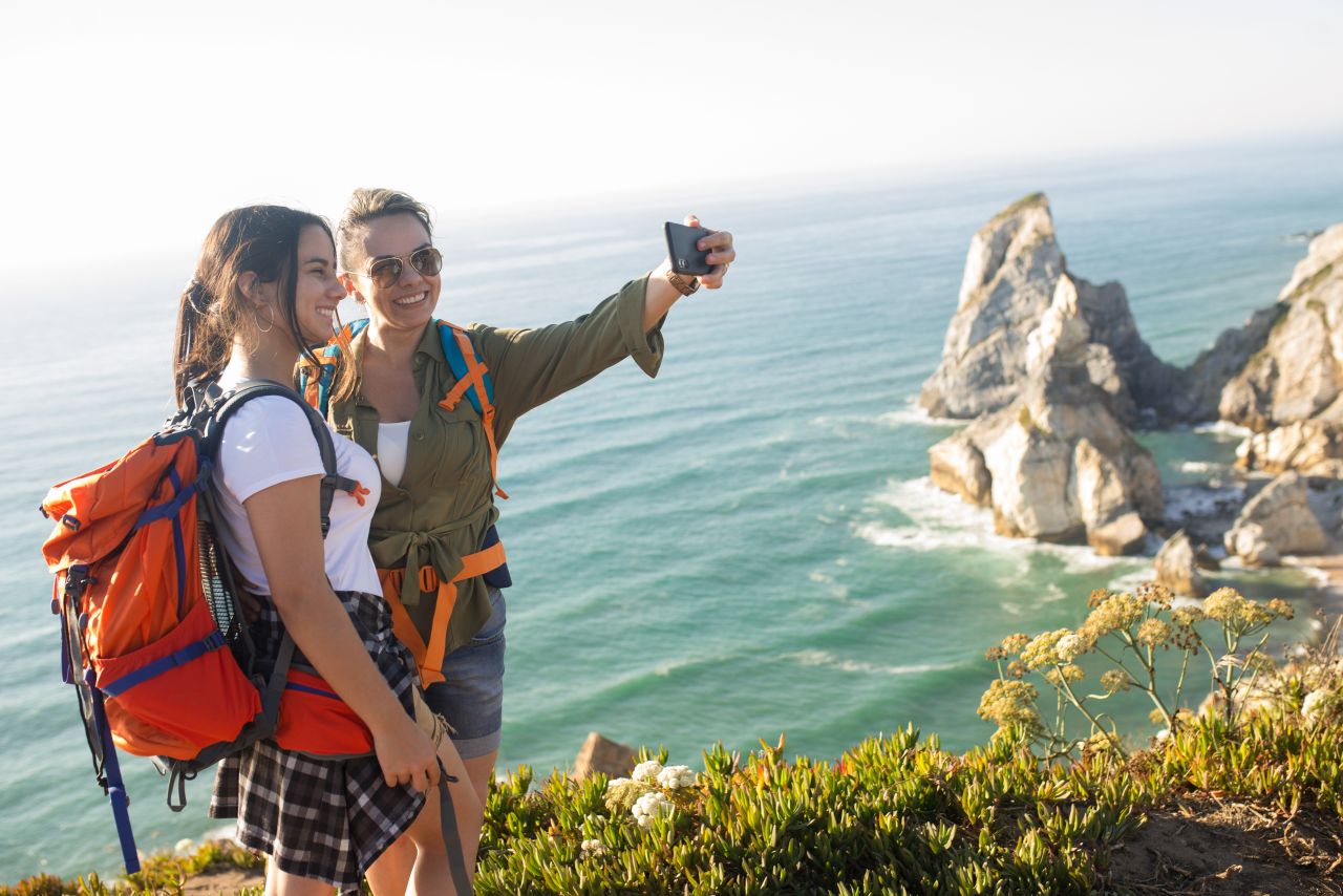 Happy mid adult woman taking selfie with daughter